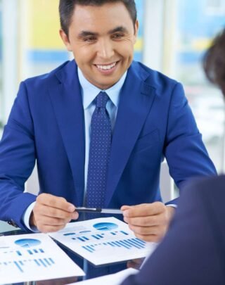 happy-businessman-with-diagrams (1)